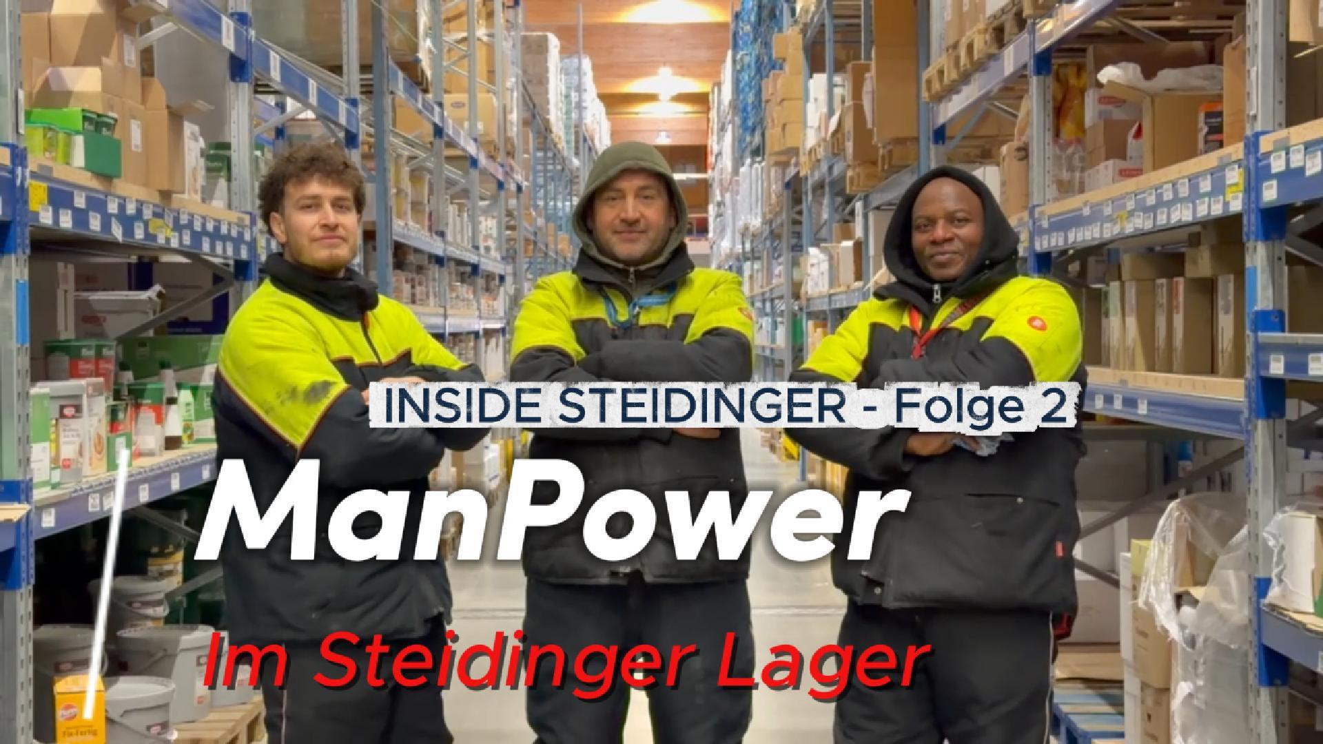 Manpower im Lager vom Lebensmittelgroßhändler Steidinger Eine Gruppe von Männern in einem Lagerhaus, lächelnd und in Jacken gekleidet.
